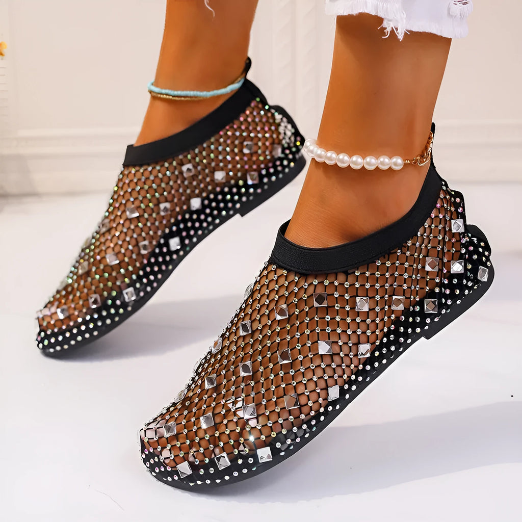 Women's flat sandals with mesh upper, colourful rhinestone design, and round toe on a rubber sole.