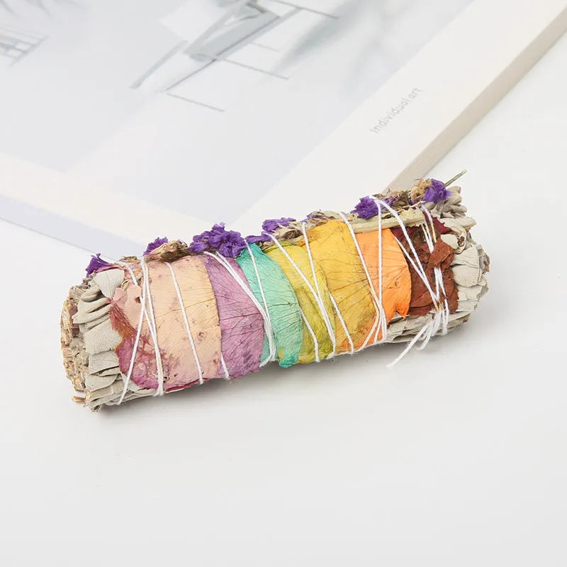 White sage and red rose petal colourful aromatherapy incense bundle on a wooden table