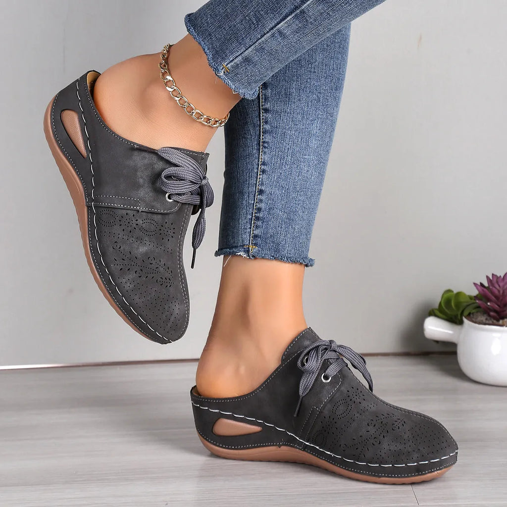 Women's suede lace-up wedge sandals in light grey showing hollow-out design and rubber sole