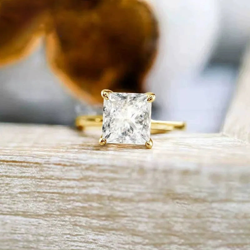 A 925 sterling silver ring with a single round cubic zirconia stone on a geometric band.
