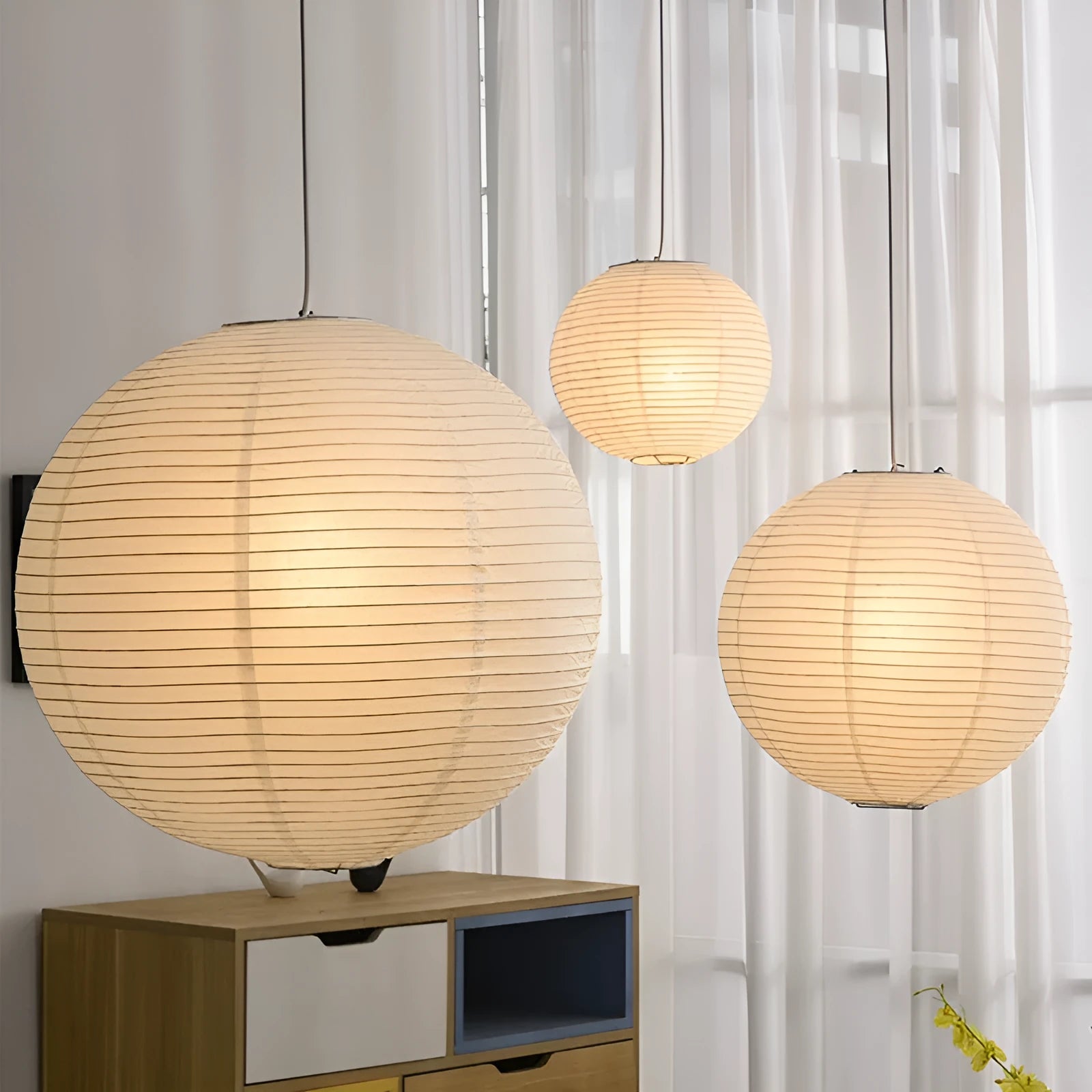 Modern minimalist paper pendant lamp with either flat disc or spherical shade, shown as a ceiling light.