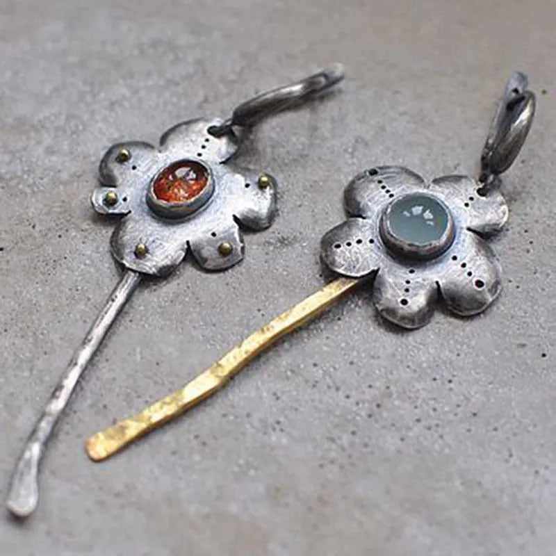 Geometric floral retro earrings with two-tone asymmetrical design and long drop style.