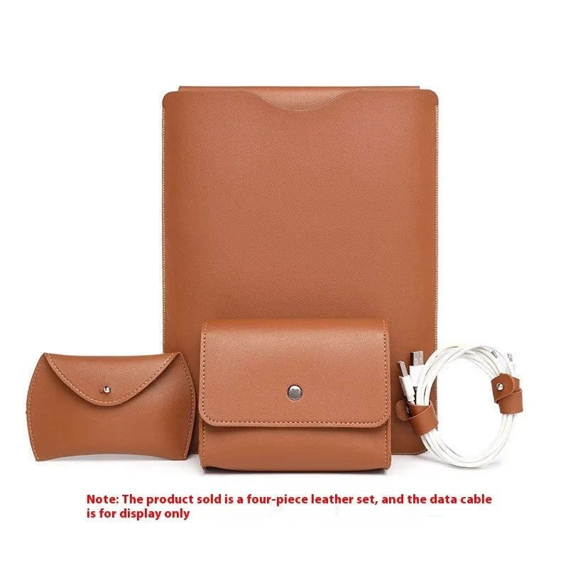 Set of four brown imitation leather laptop corner protectors on a grey laptop.
