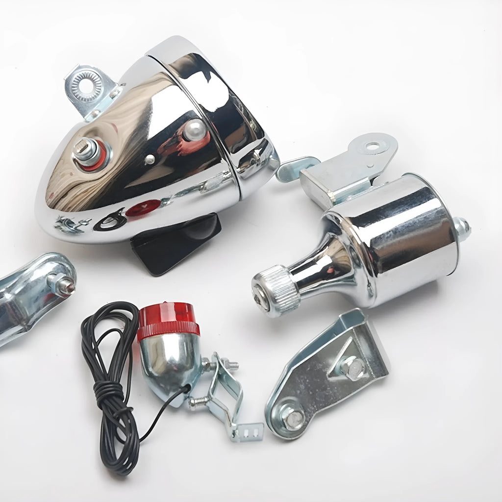 Silver bicycle dynamo-powered generator light kit mounted on a bicycle frame for front and rear lighting.
