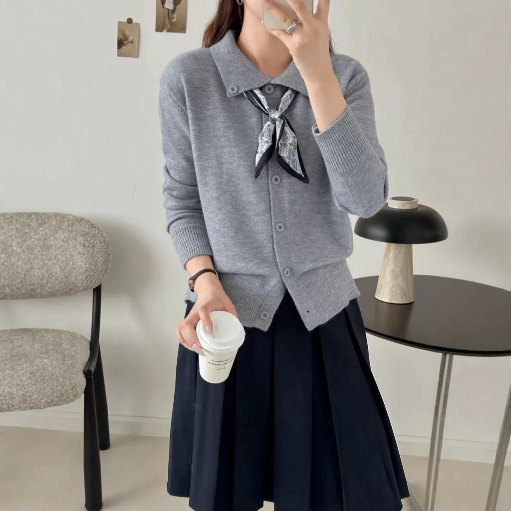 Acrylic fibre lazy fashion cardigan sweater with integrated lapel scarf in a neutral colour.
