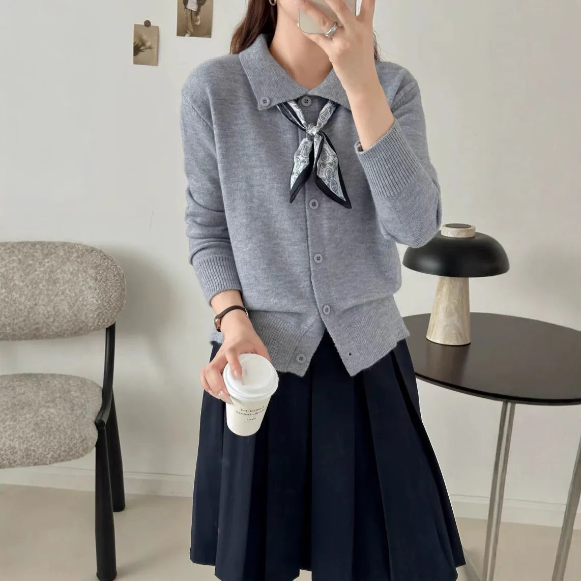 Acrylic fibre lazy fashion cardigan sweater with integrated lapel scarf in a neutral colour.