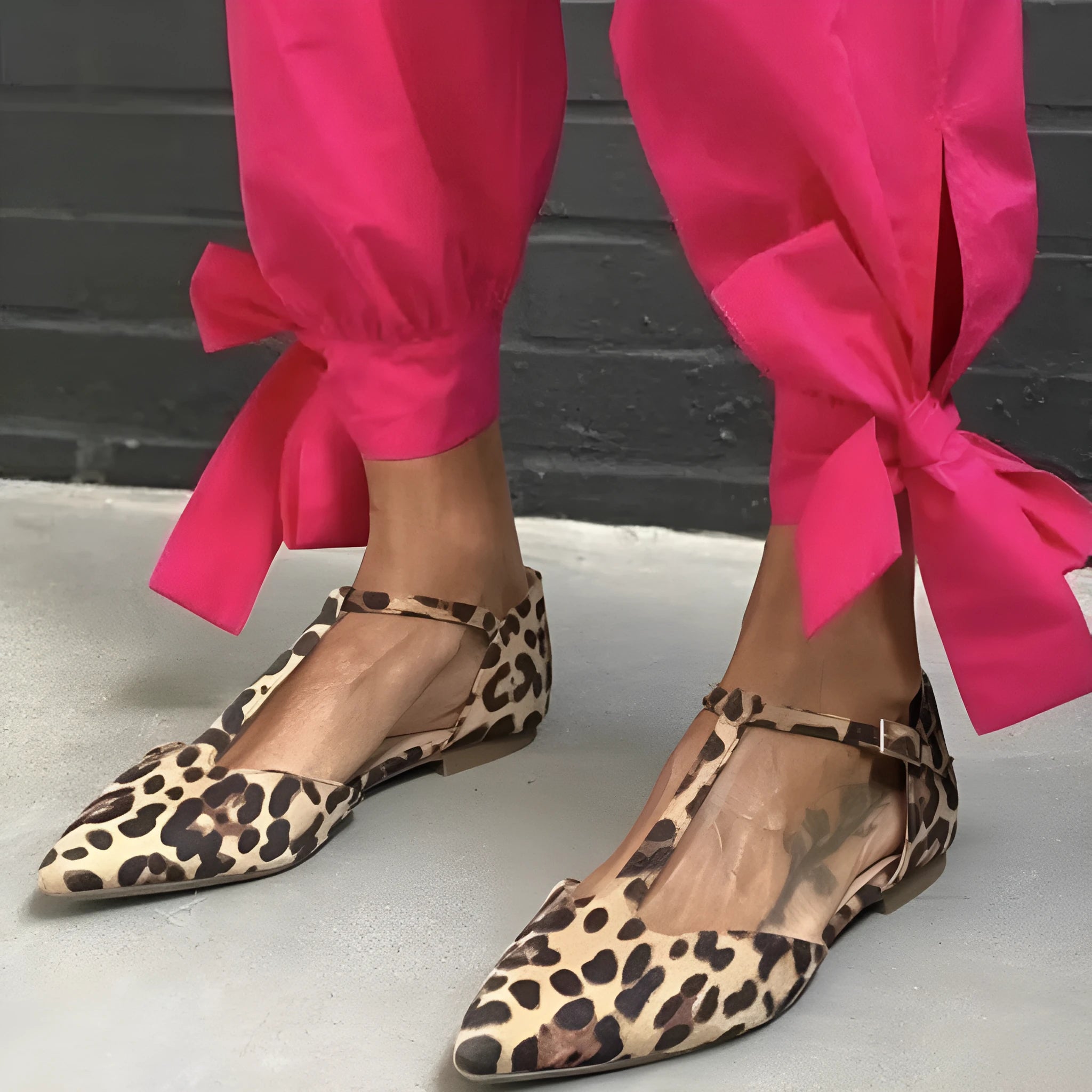 Leopard print women's pointed toe pumps with a low chunky heel and a cross ankle strap.