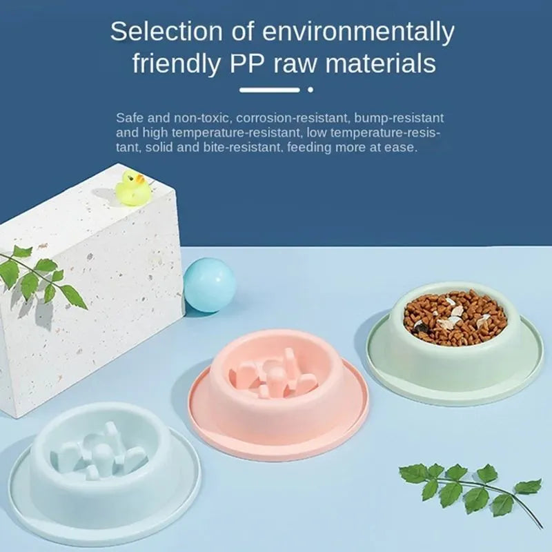 Blue pet slow feeder bowl with raised obstacles on a kitchen floor.