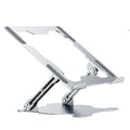 Grey portable aluminum laptop stand shown folded and in use with a silver laptop, demonstrating its adjustable angle.