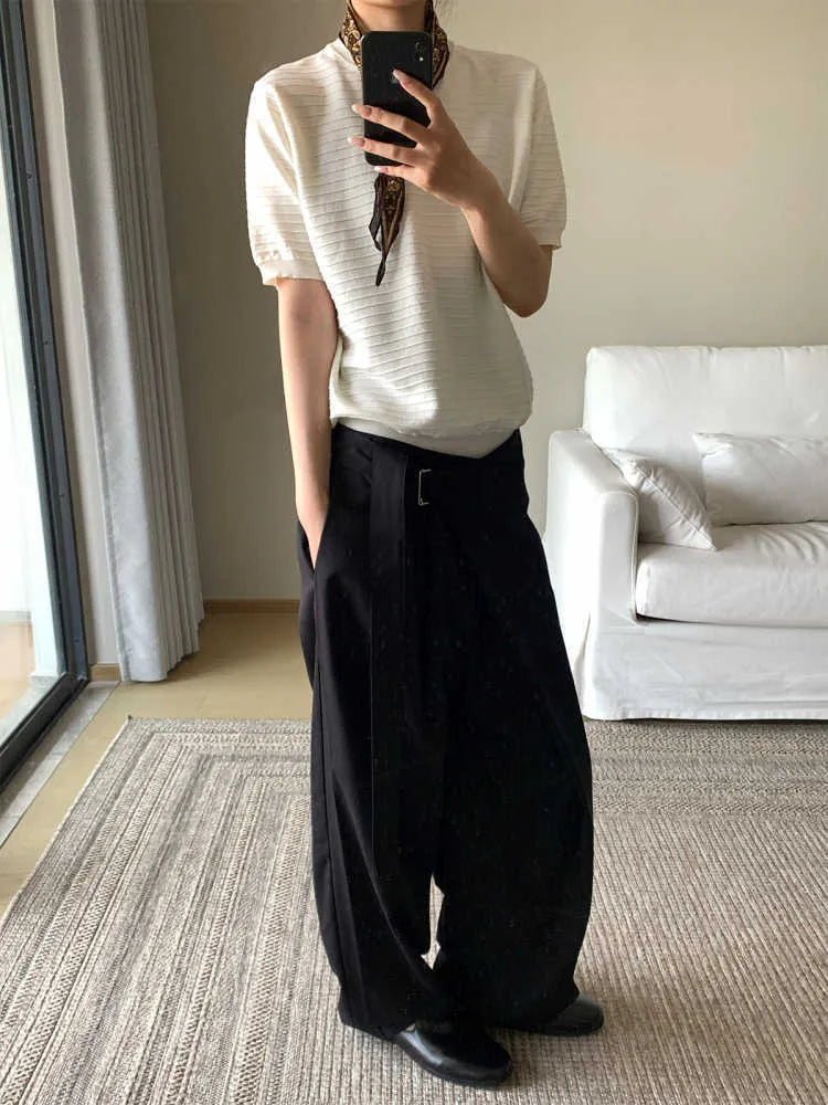 Black women's straight-leg trousers with a single pleat front and adjustable waistband on a hanger.
