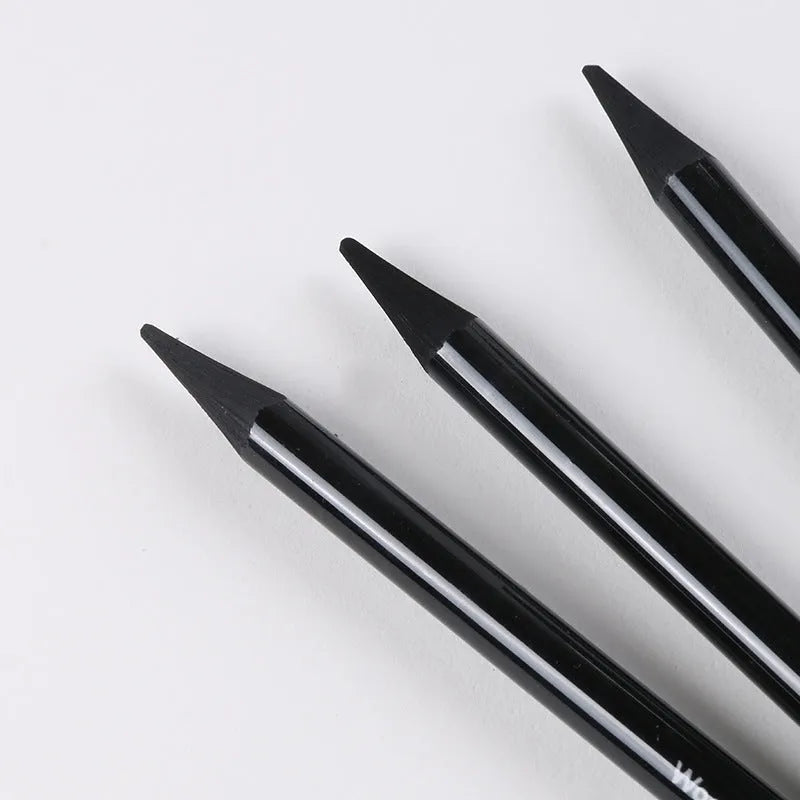 Set of six graphite and three carbonised drawing pencils on suction card packaging