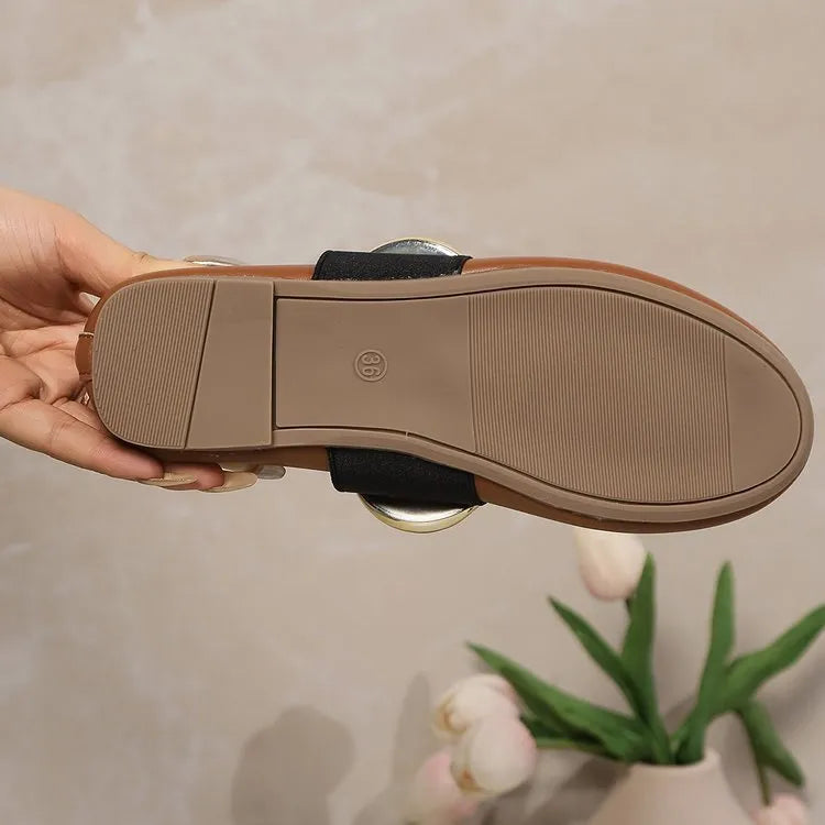 Women's brown flat loafers with metal buckle and round toe on artificial PU upper