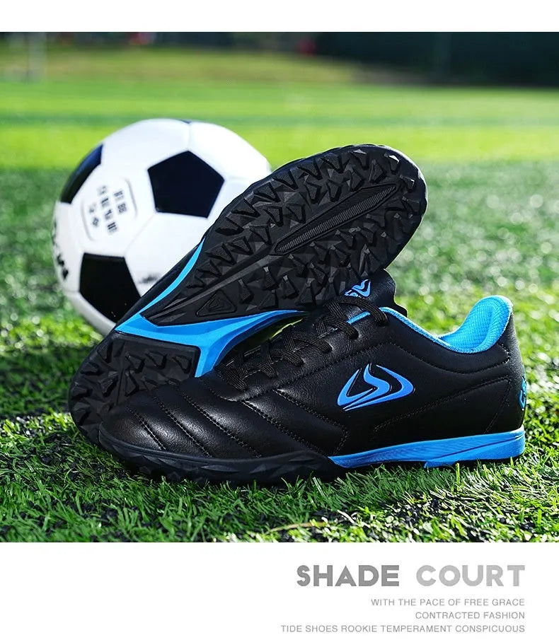 Low-top turf soccer shoes in black and white broken nails colour with synthetic leather upper