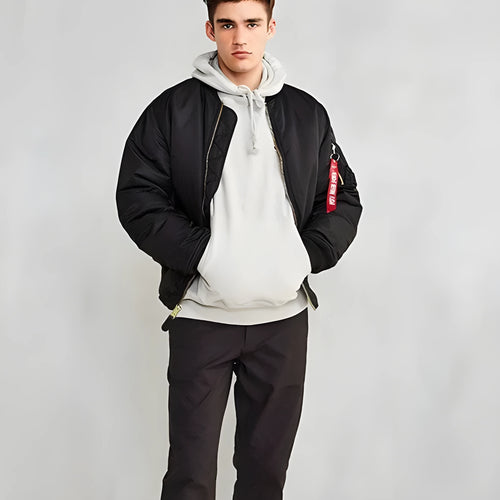 Man wearing a reversible army green nylon pilot jacket, showing the double-sided workwear design.