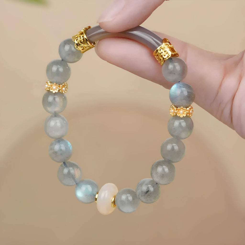 Grey moonstone bracelet with 8mm round beads on a wrist.
