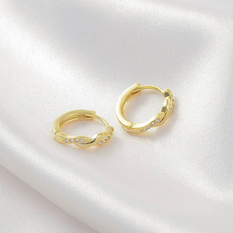 Geometric interwoven hemp rope earclip earrings in gold or silver colour on a copper base.