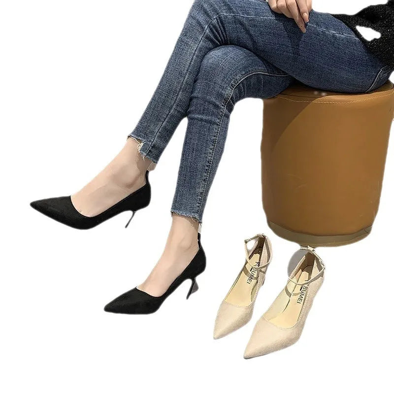Black and white women's stiletto high heel shoes with skull pattern and ankle buckle.
