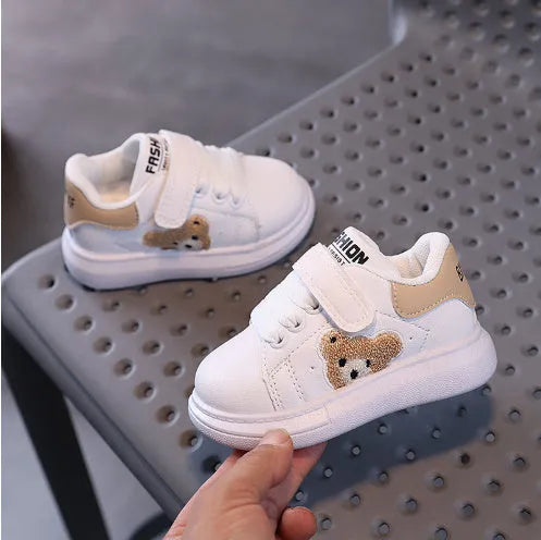 Children's black casual sports shoes with a cartoon bear design on the side, featuring an artificial leather upper and rubber sole.