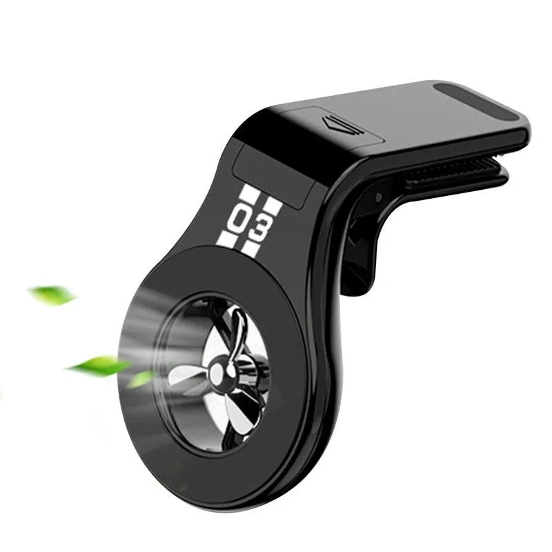 Black magnetic car phone holder with perfume slices, clipped on a car air vent