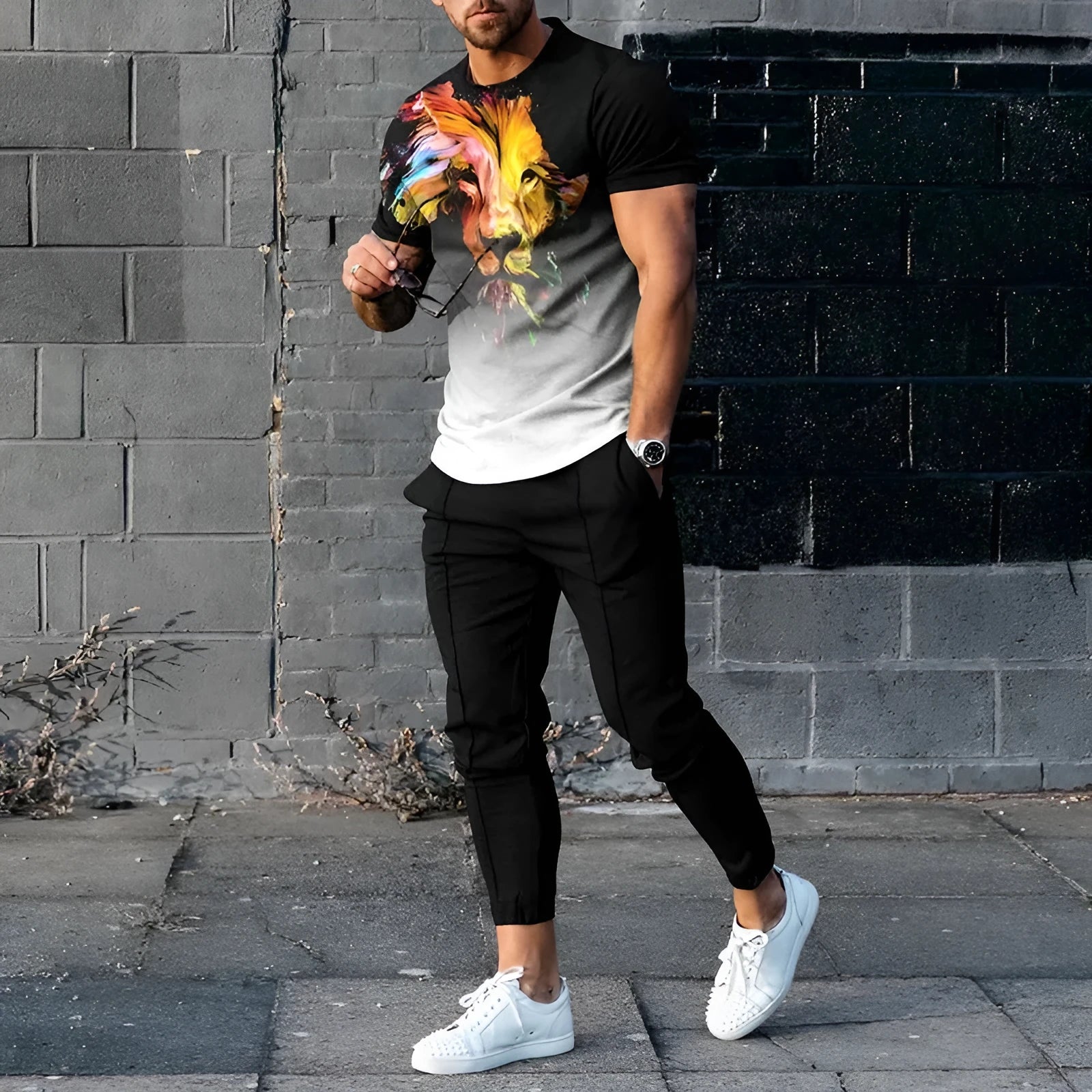 Man wearing a thin, short-sleeved printed pullover and matching trousers from a polyester blend sport suit set.