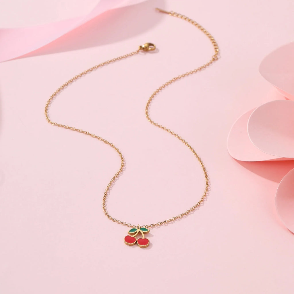 Stainless steel 18K gold plated cherry jewellery set showing necklace, bracelet, earrings, and ring.