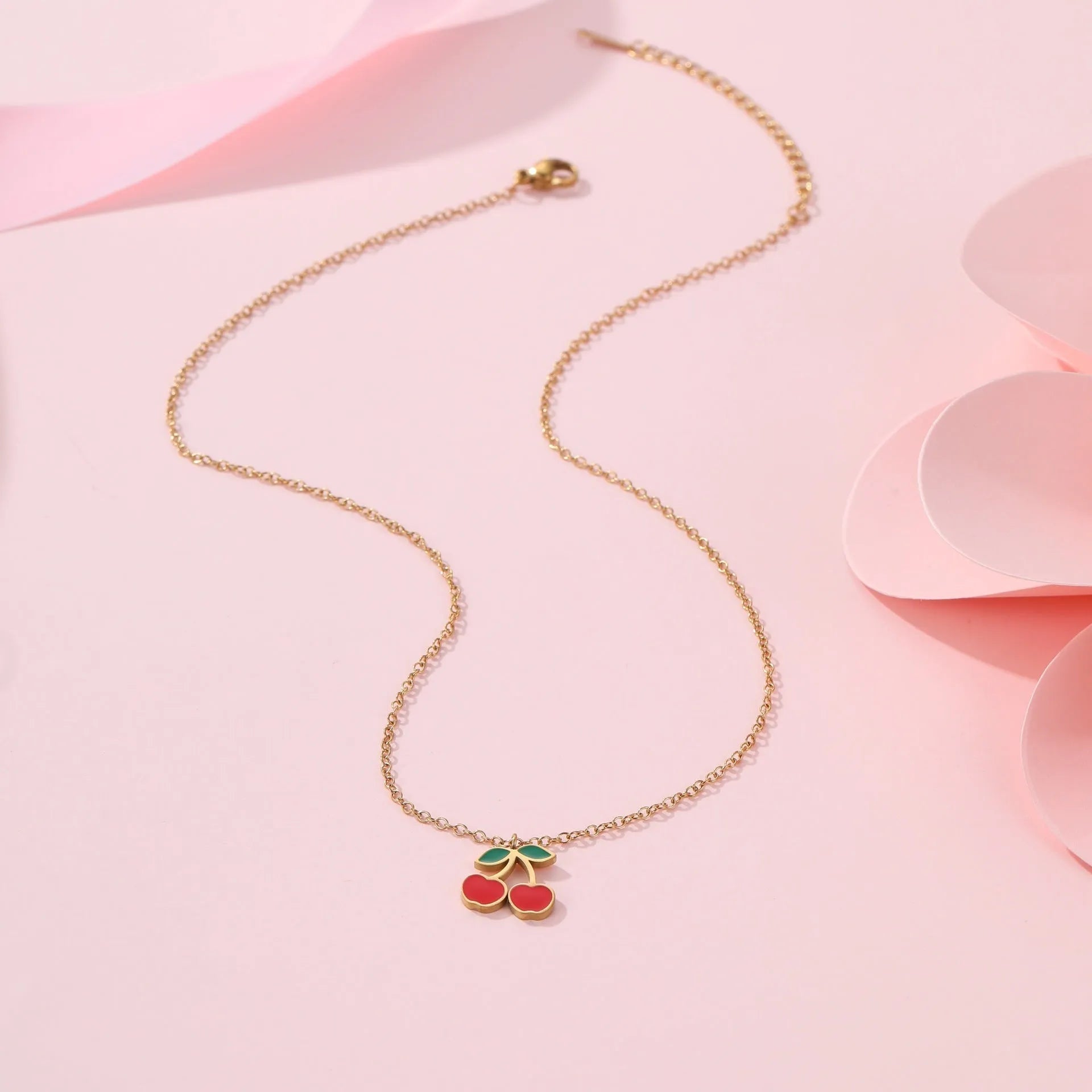 Stainless steel 18K gold plated cherry jewellery set showing necklace, bracelet, earrings, and ring.