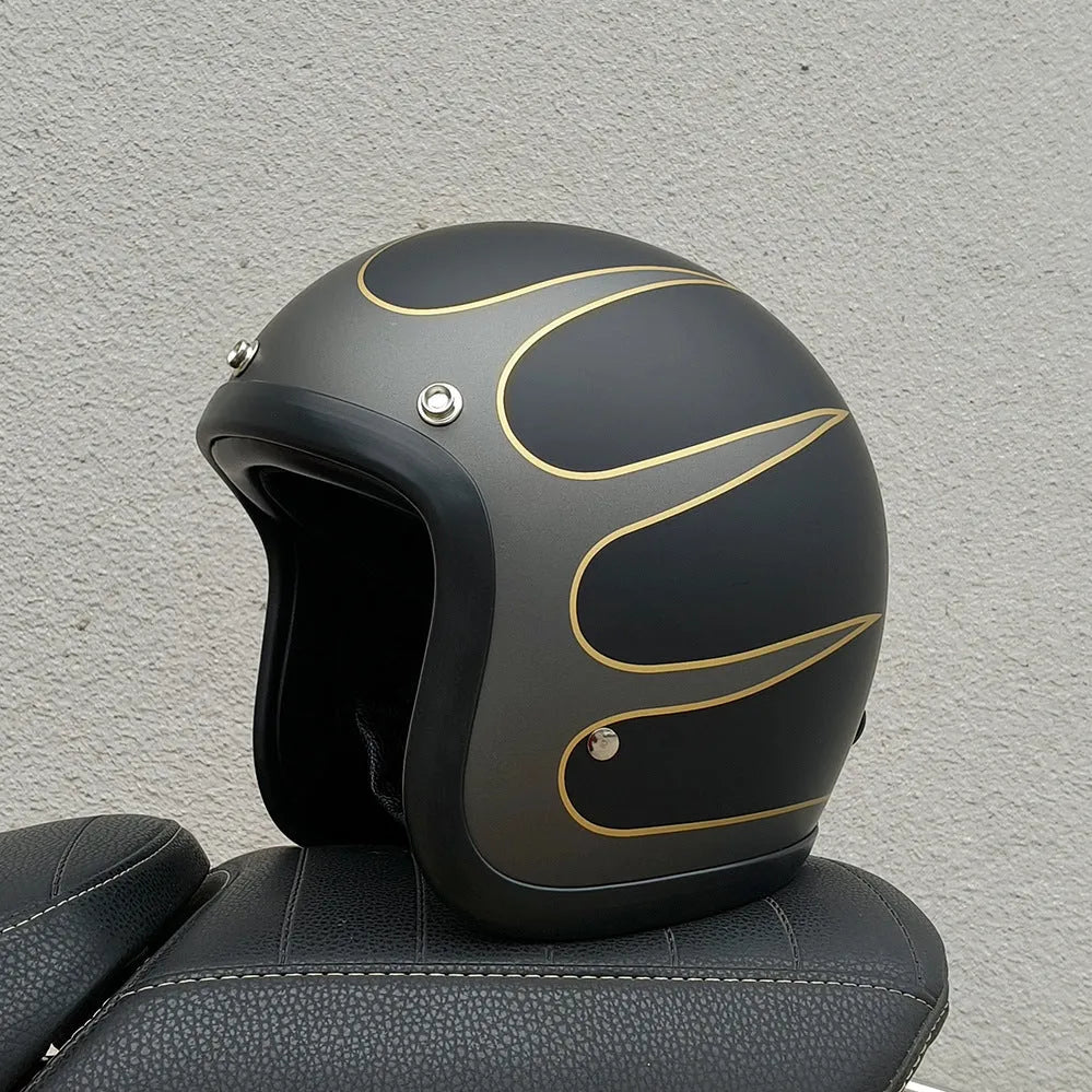 Retro-style open face motorcycle helmet in fibreglass, shown in a selection of colours including cement grey and matte black.