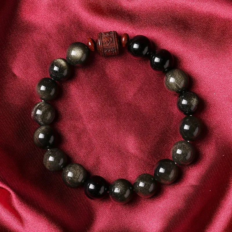 Golden obsidian vintage bracelet with hand-woven construction and national style design elements