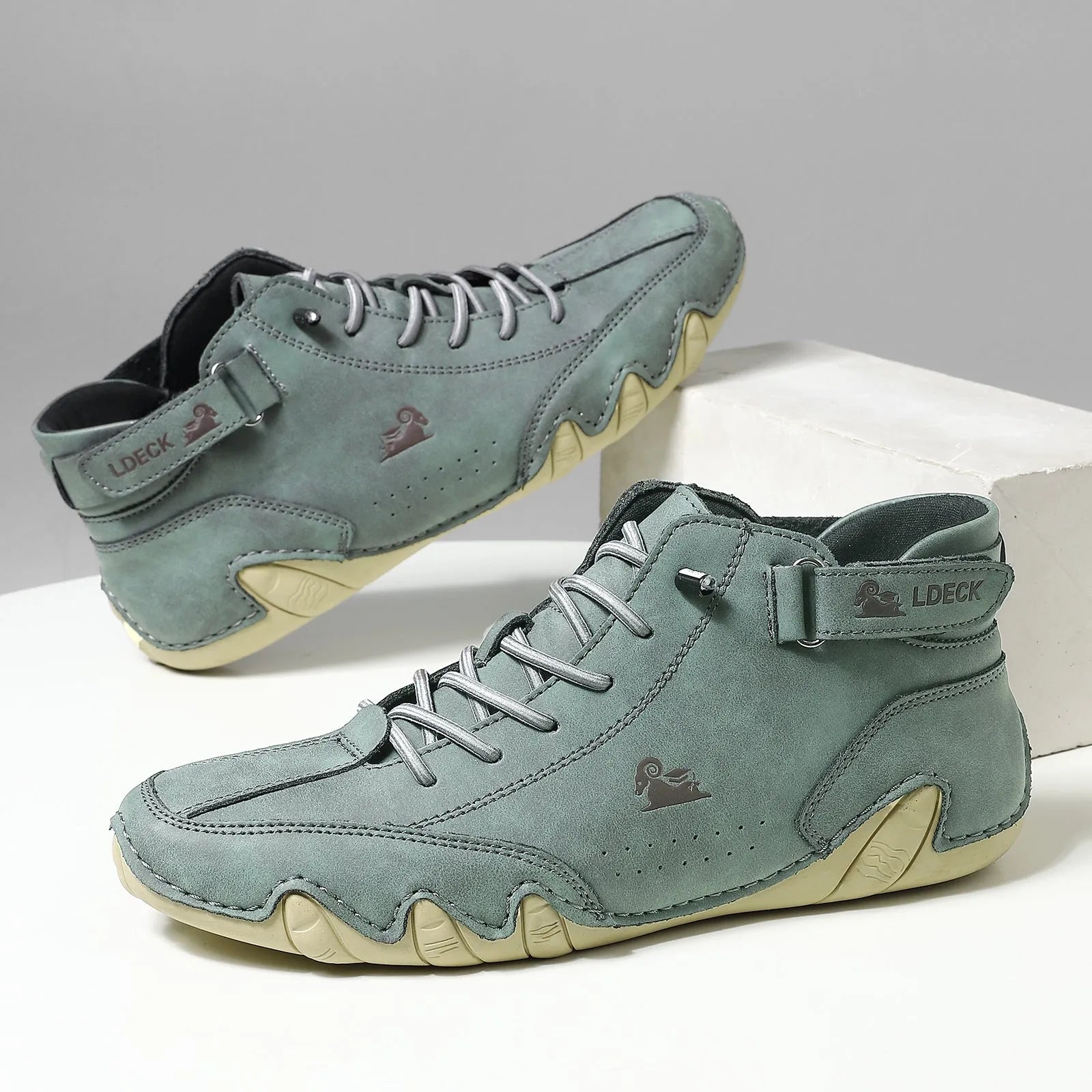 Men's khaki high top boots with octopus design, rubber sole, and pigskin ankle collar.