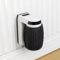 White automatic cat self groomer with silicone bristles mounted in wall corner