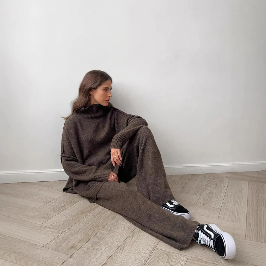 Women's knitted two-piece suit with side-slit sleeve jumper and trousers in dark grey.