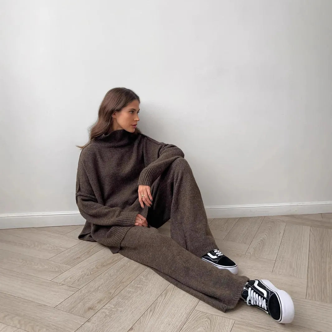 Women's knitted two-piece suit with side-slit sleeve jumper and trousers in dark grey.