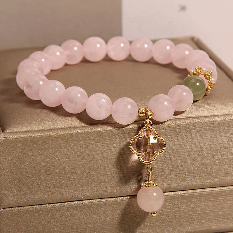 Pink crystal four-leaf clover pendant bracelet with alloy setting and rhinestone details