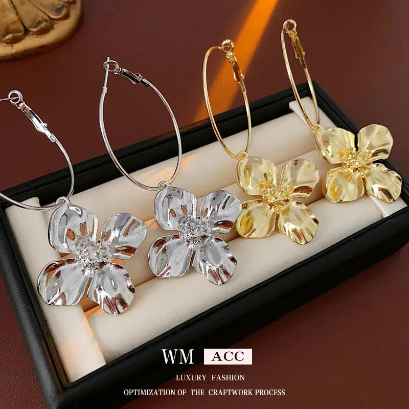 Gold and silver vintage metal flower earrings with geometric design and a silver needle detail.