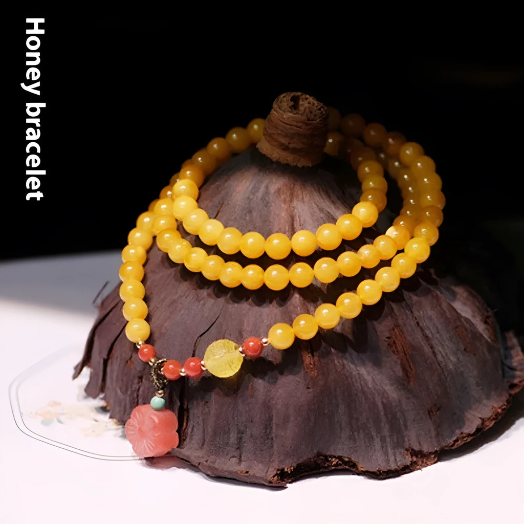 Yellow chicken grease beeswax design on 5mm amber bracelet with animal zodiac modelling
