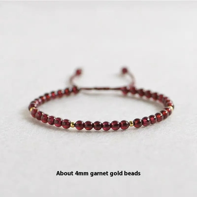 Hand-woven garnet red bracelet with flexible wire rope construction and Chinese national tide design