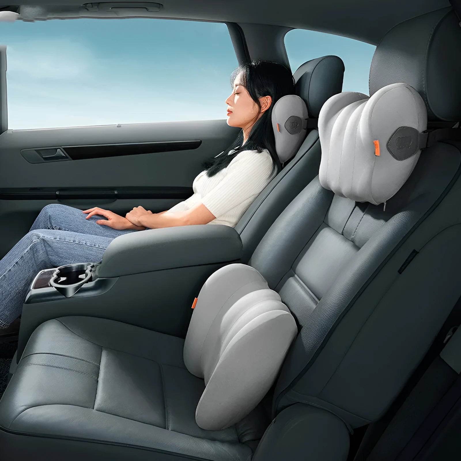 Grey and orange head restraint and lumbar pillow set for vehicle seats.