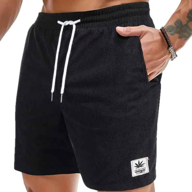 Man wearing grey straight leg drawstring summer shorts made from elastic fabric.