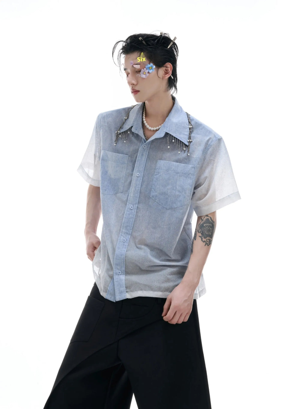 Blue and white gradient short-sleeved loose fit shirt on a hanger.