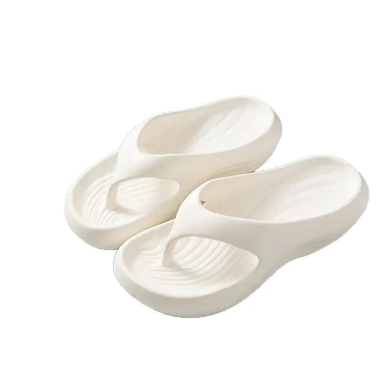 Black women's flip-flops with thick sole and textured non-slip tread.