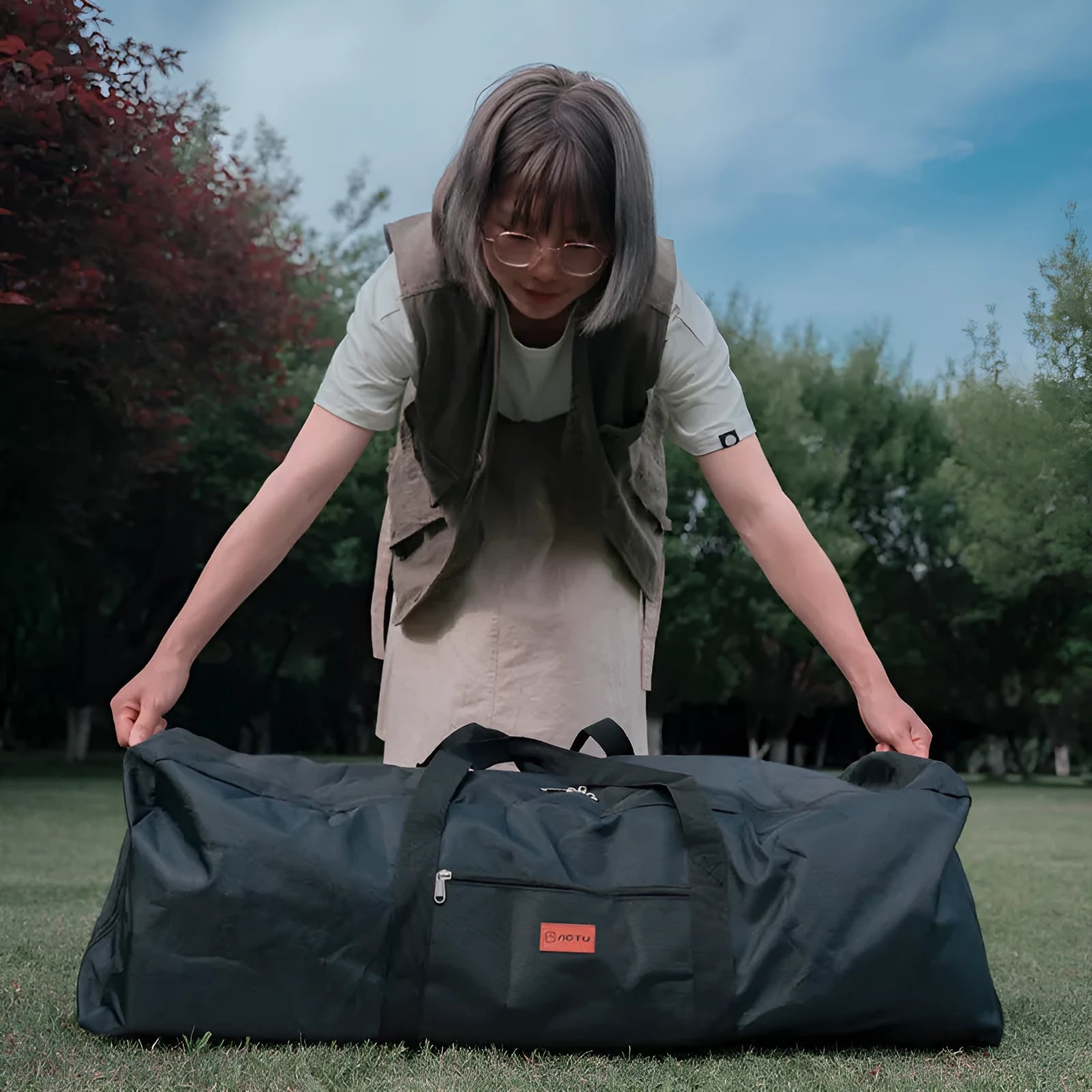 Green waterproof camping storage bag shown expanded and compressed, holding a folding chair and tent.