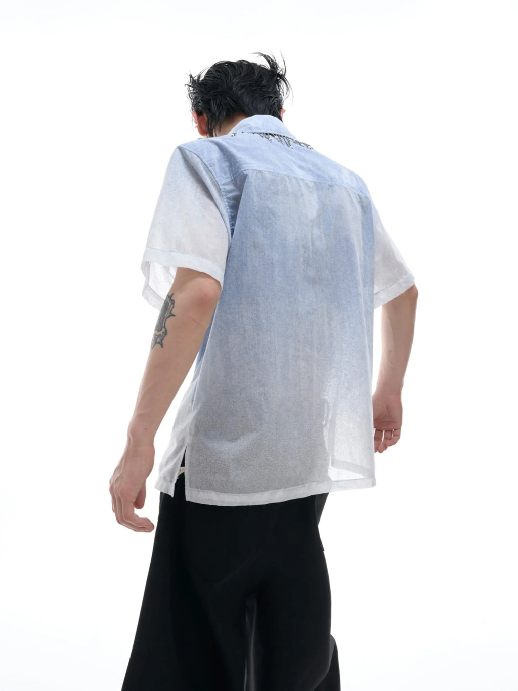 Blue and white gradient short-sleeved loose fit shirt on a hanger.