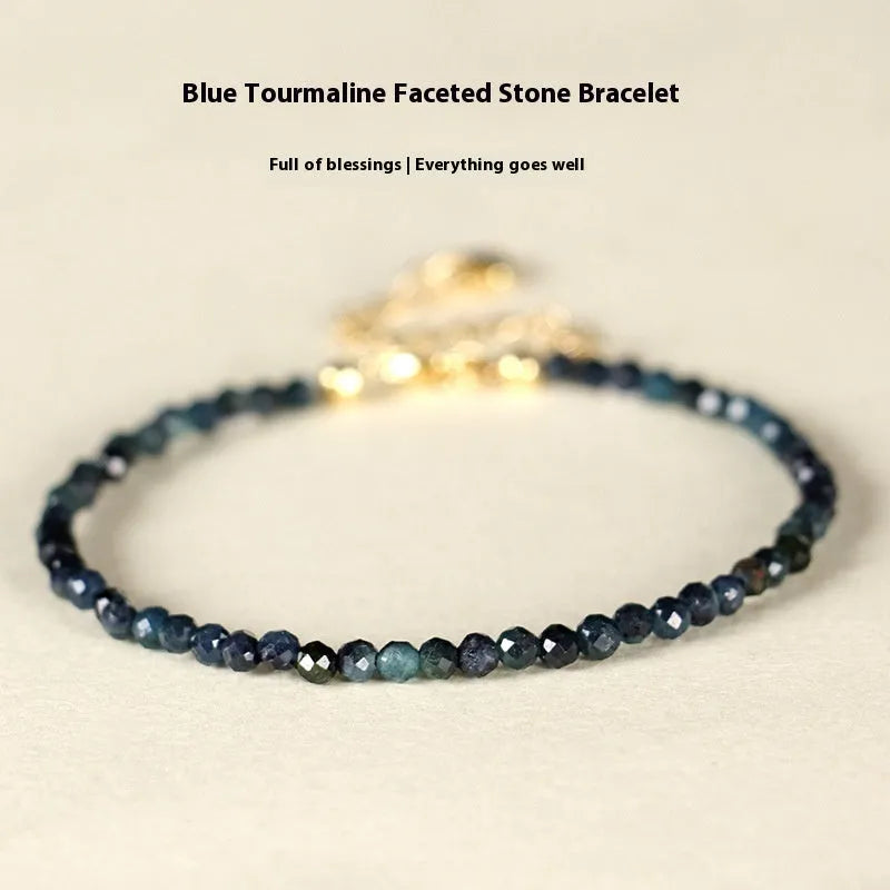 Blue tourmaline bracelet with 3mm beads and metal spacer sections on wrist