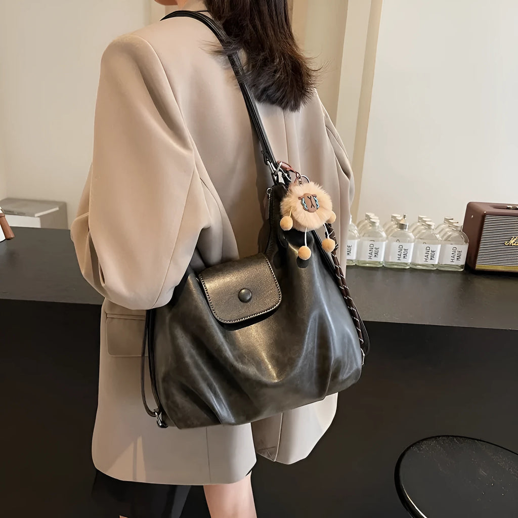 PU leather commuter backpack in horizontal square shape with single shoulder strap