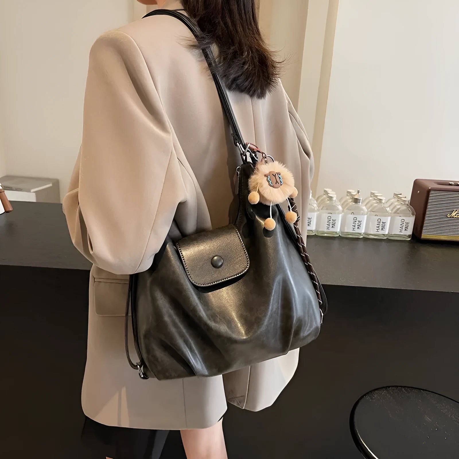 PU leather commuter backpack in horizontal square shape with single shoulder strap