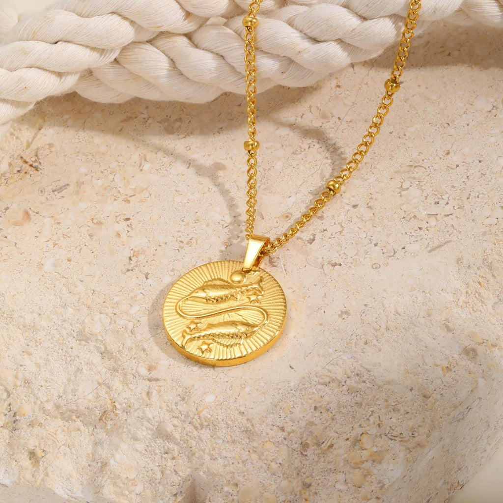 Stainless steel bead necklace with a round pendant embossed with a zodiac constellation, on a cross chain.