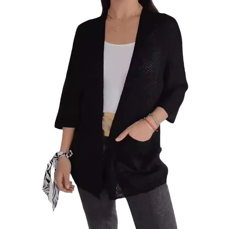 Women's longline waffle-textured cardigan coat in army green, showing pocket detail and nine-quarter sleeve length.
