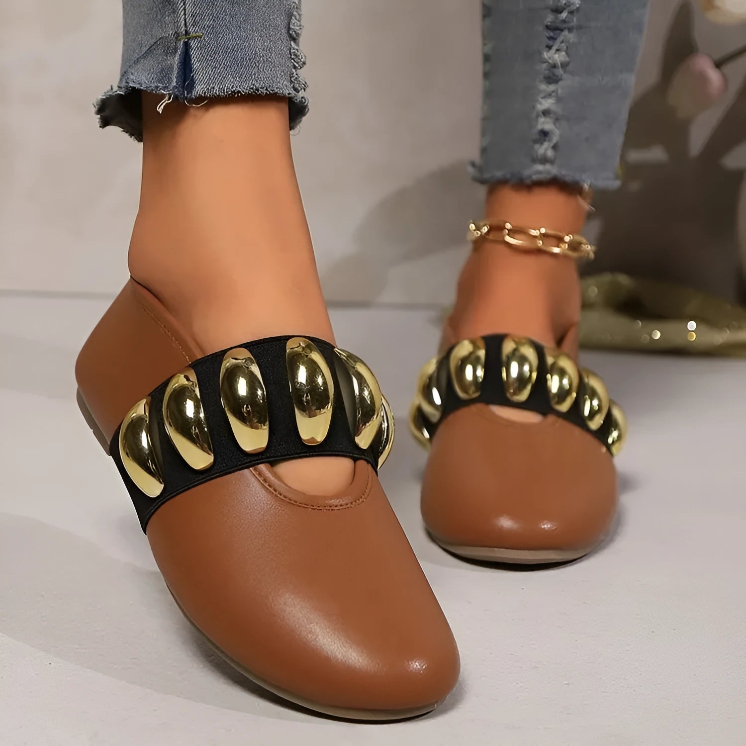 Women's brown flat loafers with metal buckle and round toe on artificial PU upper