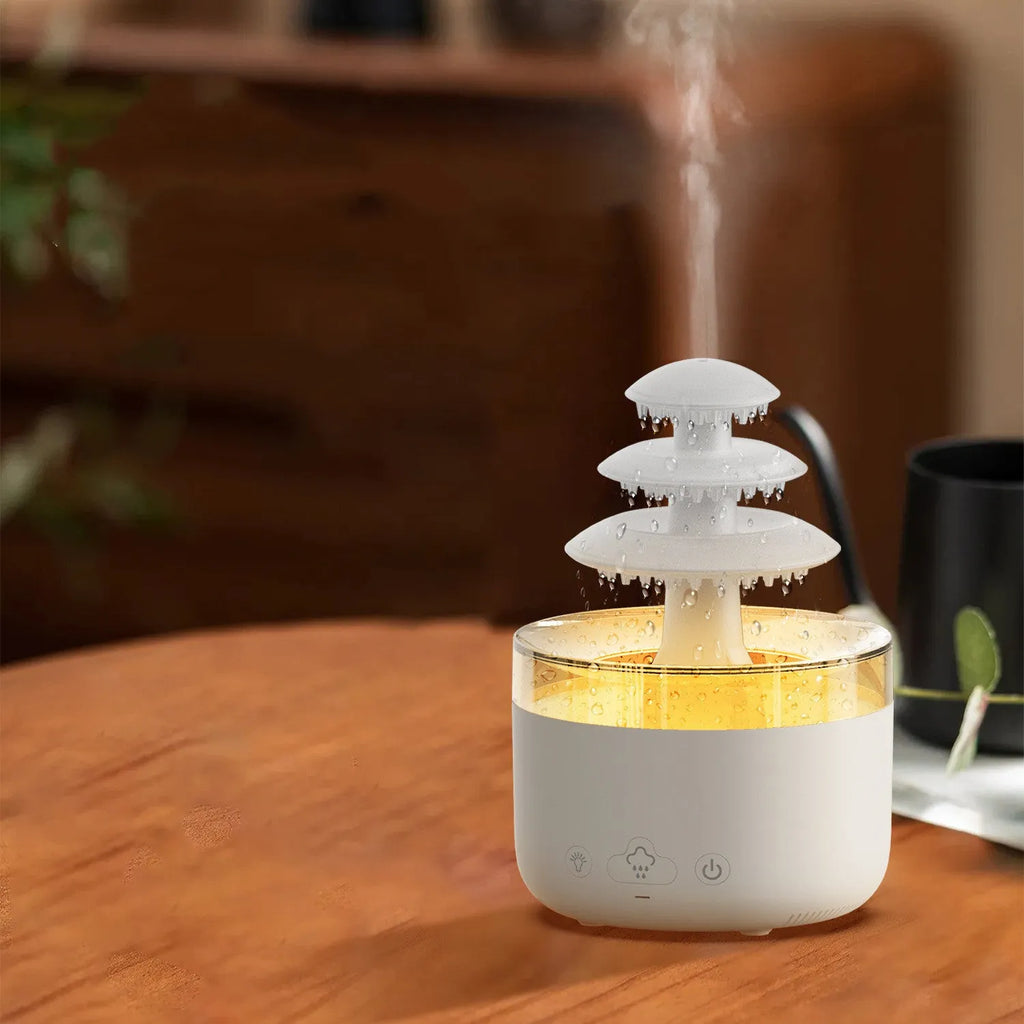 White cloud-shaped ultrasonic humidifier and essential oil diffuser with colourful LED light on base.