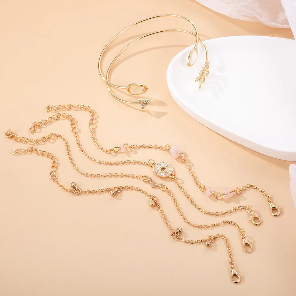 Gold-coloured zinc alloy women's bracelet set with six European-inspired designs including water drop and arrow shapes